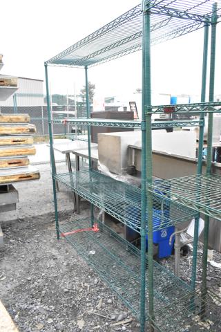 Green 4-tier wire shelving unit outdoors. Good condition. Buyer must dismantle. Consider freight charges.