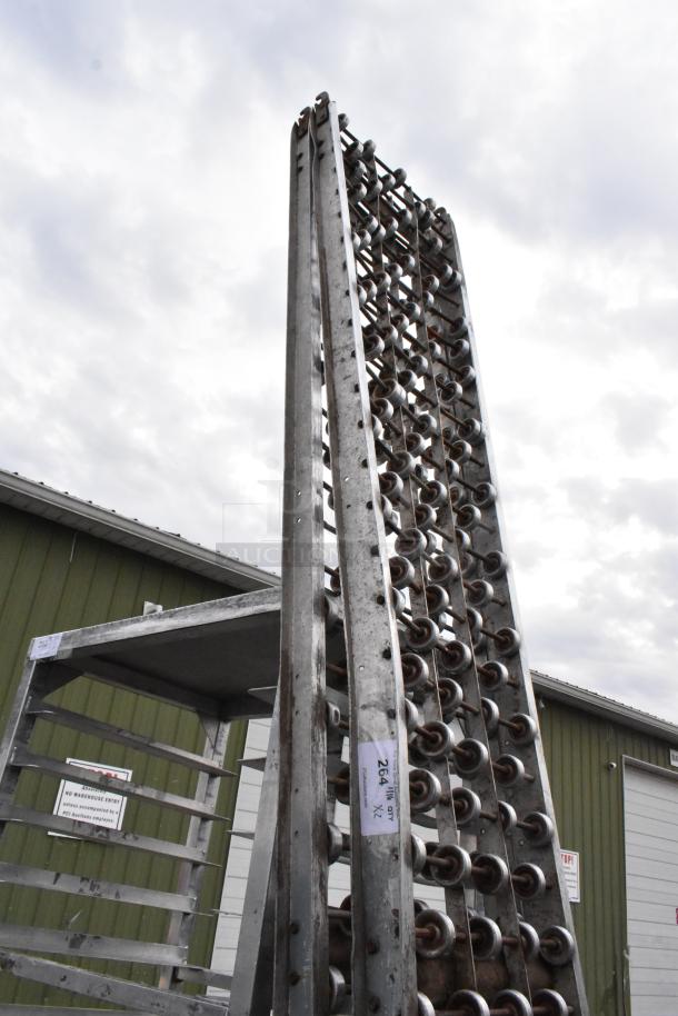 Two metal rolling conveyor belts in used condition, vertical alignment. Visible label reads "264A X2." Suitable for industrial use.