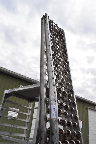 Two metal rolling conveyor belts in used condition, vertical alignment. Visible label reads "264A X2." Suitable for industrial use.