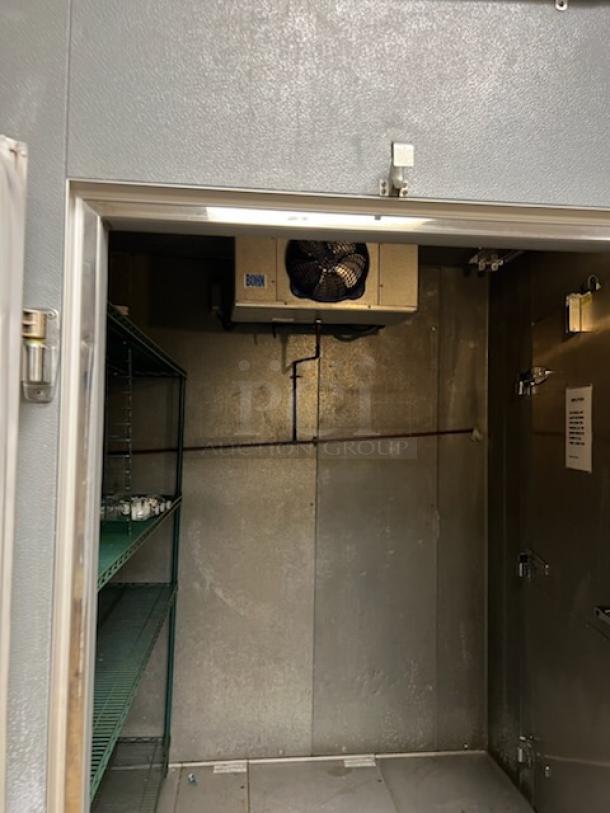 Norlake walk-in cooler interior view with shelving and evaporator fan. Stainless steel walls, good condition.