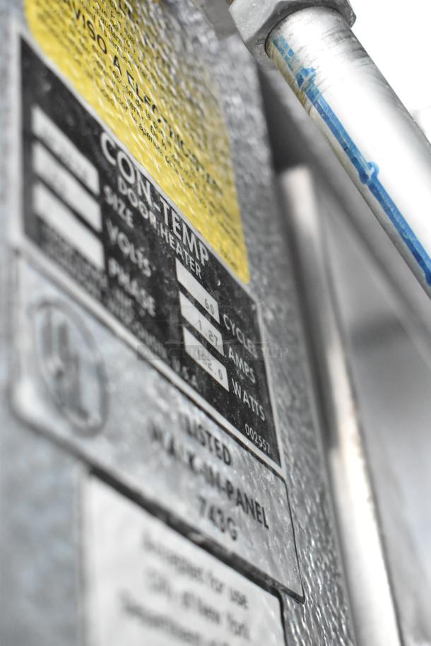 Norlake walk-in cooler and freezer combo, featuring product tags showing electrical specifications and safety standards.