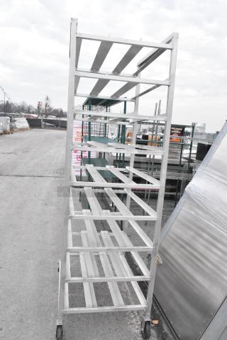 Channel CSR-9M metal commercial pan rack with multiple shelves, features durable commercial casters, in good condition.