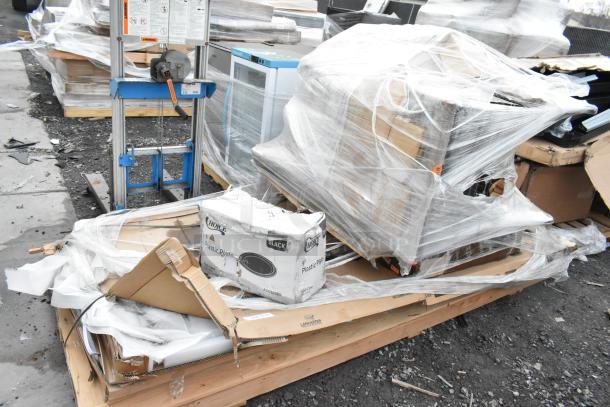 5 new scratch and dent items, including Lancaster Tabletop and Choice plastic plates, wrapped on a wooden pallet.