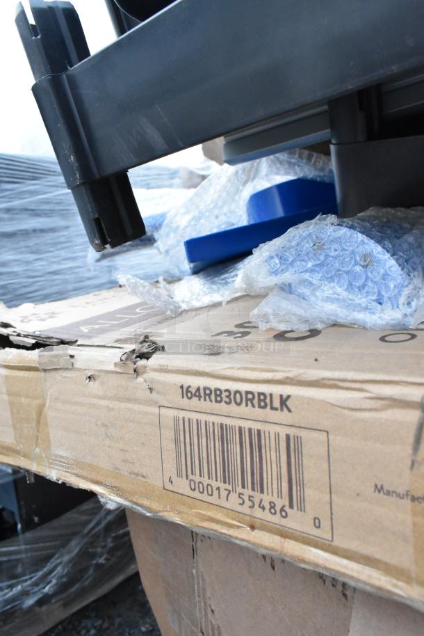 Cardboard box labeled "164RB30RBLK" amid bubble wrap and plastic wrap. Scratch and dent condition items inside.