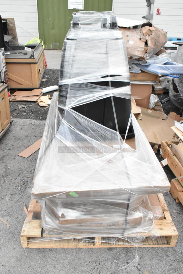 Plastic-wrapped pallet with new scratch and dent items, including over shelf and wire shelves. Packaging intact, items visible inside.
