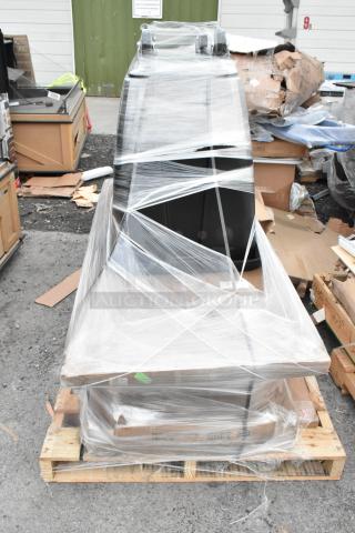 Plastic-wrapped pallet with new scratch and dent items, including over shelf and wire shelves. Packaging intact, items visible inside.