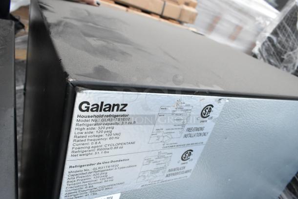 Four mini coolers including Haier and Galanz models; features visible label for Galanz GLR31TS1E02, 120 volts, 1 phase.