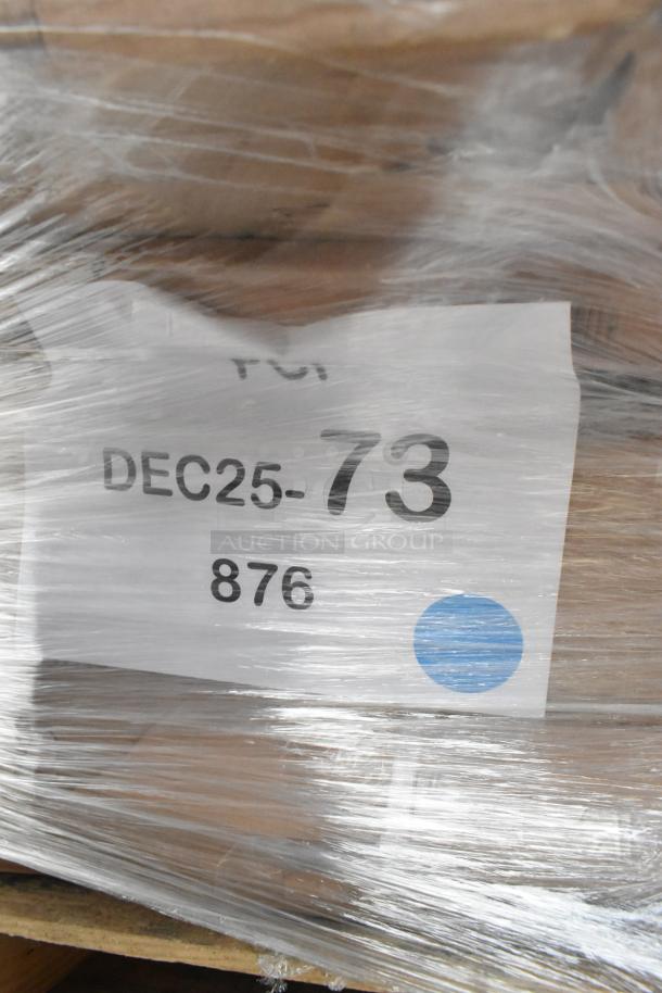 Shrink-wrapped pallet with label showing "DEC25-73 876." Contains 8 new scratch and dent items: grease trap, drying rack, work table, trash can.