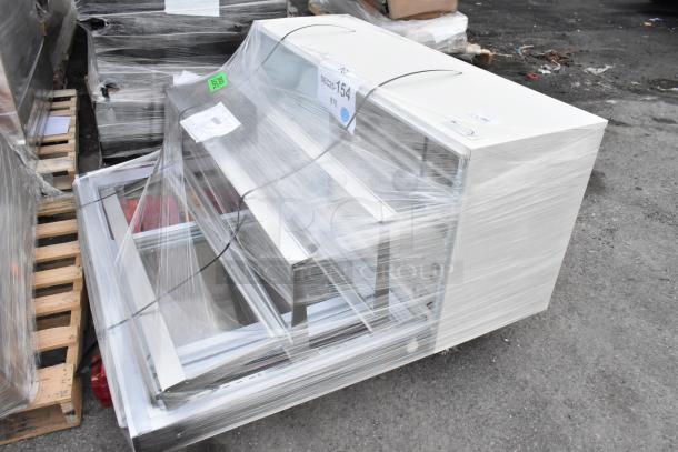 Brand new Avantco BCFD-60 white bakery display case, 59 1/8", LED lighting, visible scratch and dent, wrapped on pallet.