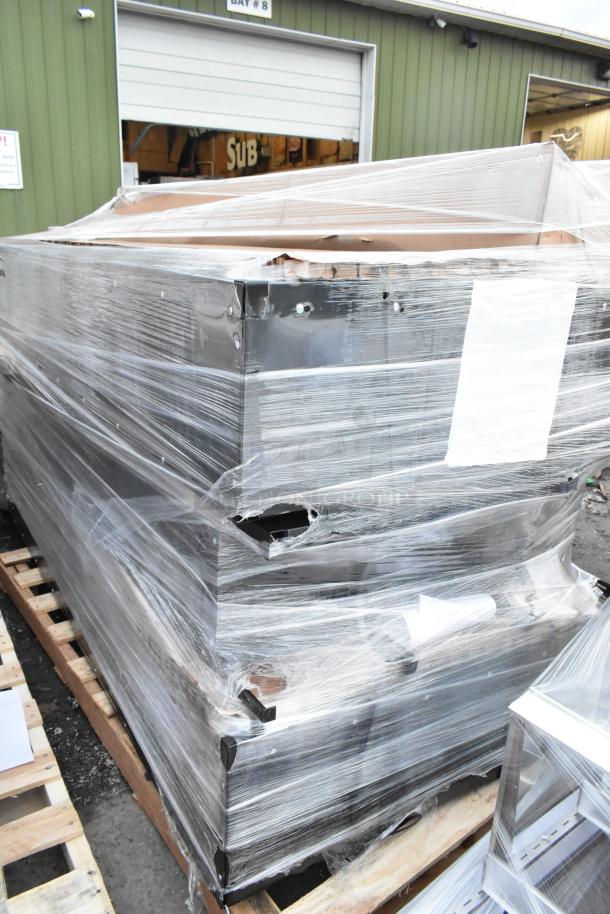 Plastic-wrapped black metal lockers stacked on pallets, showing minor dents, labeled "4 BRAND NEW SCRATCH AND DENT!"