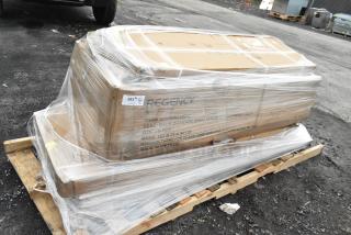 Shrink-wrapped pallet containing Regency items, including wall shelf and work table, labeled as scratch and dent, new condition.