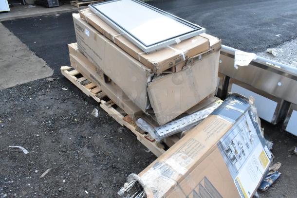 9 brand new scratch and dent items on a pallet, including a dunnage rack and shelving unit. Boxes show slight damage.