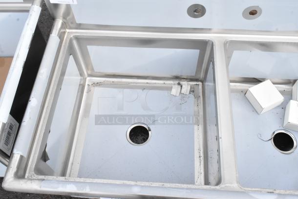 Three-compartment Regency 600S32323 stainless steel sink, 78" with 23" x 23" x 12" bowls. Scratch and dent condition.