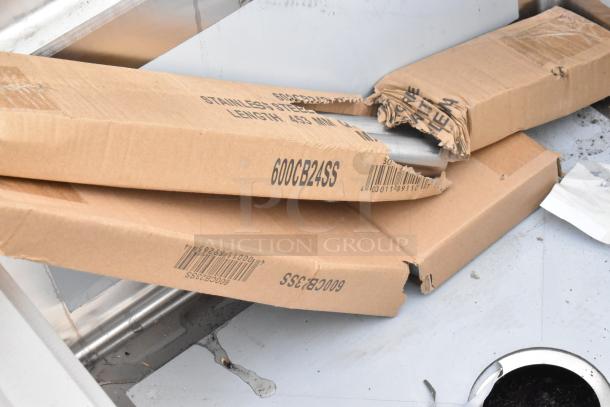 New Regency 600S32323 78" 16-gauge stainless steel three-compartment sink, visible scratches and dented packaging, no drainboards.