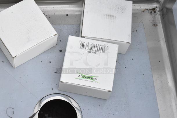 Brand new Regency 600S32323 stainless steel triple sink, slight scratches, no drainboards, 23"x23"x12" bowls, seen with protective packaging.