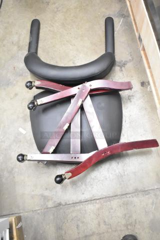 Disassembled chair parts including seat, curved backrest, and four wooden legs with caster wheels; parts appear intact.