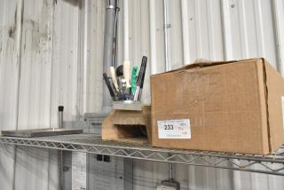 Lot of various items including utensils and a metal panel on a shelf; box labeled "233 QTY Tier lot".