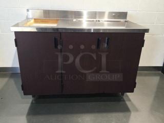 Custom stainless steel counter cabinet with dual sink and trash cutout, immaculate condition, commercial grade, fully inspected.