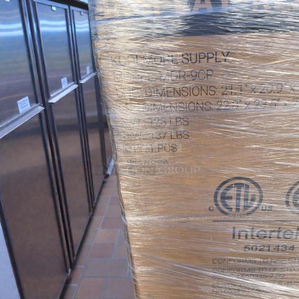 Brand new KoolMore MDR-9CP commercial refrigerator in original packaging. 9 Cu. Ft., ETL listed, model and shipping details visible.
