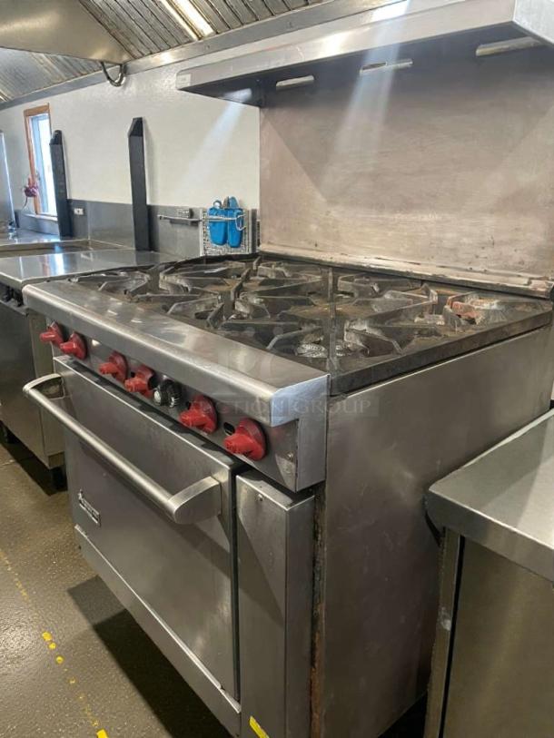 American Range commercial gas range with 6 burners, oven, stainless steel, red knobs. Premium condition, fully tested. Model: AMR-L-RNG-0097.