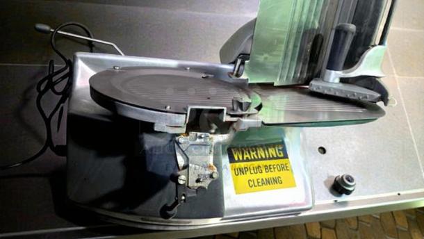 Hobart 2912 commercial meat slicer, tested and working, 120V, single phase, warning label visible, excellent condition.