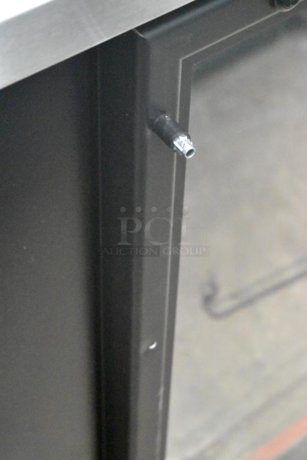 Brand new 2025 True TBB-4G-HC-LD commercial back bar cooler with three doors, metal finish, minor scratch and dent. 115V, 1 phase.