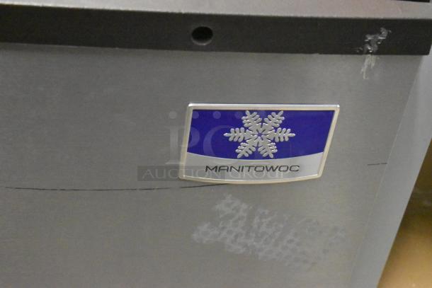 BRAND NEW SCRATCH AND DENT Manitowoc IDT0900A-261 Stainless Steel Ice Machine, 851 lb capacity, 208-230V, 1 Phase. Visible logo.