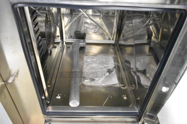 BRAND NEW Bakers Pride AEHE061R stainless steel combi convection oven, 208V, 3 phase, scratch and dent model, interior view.