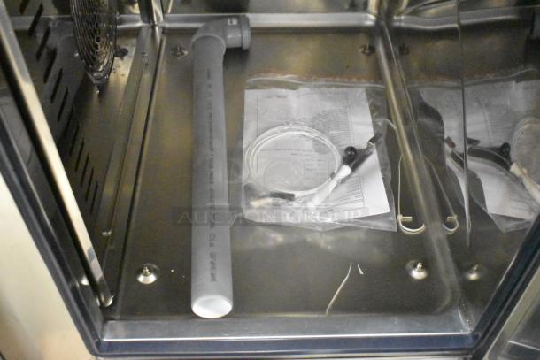 Bakers Pride AEHE061R stainless steel combi convection oven interior, new with pipe and accessories inside. 208V, 3 phase.