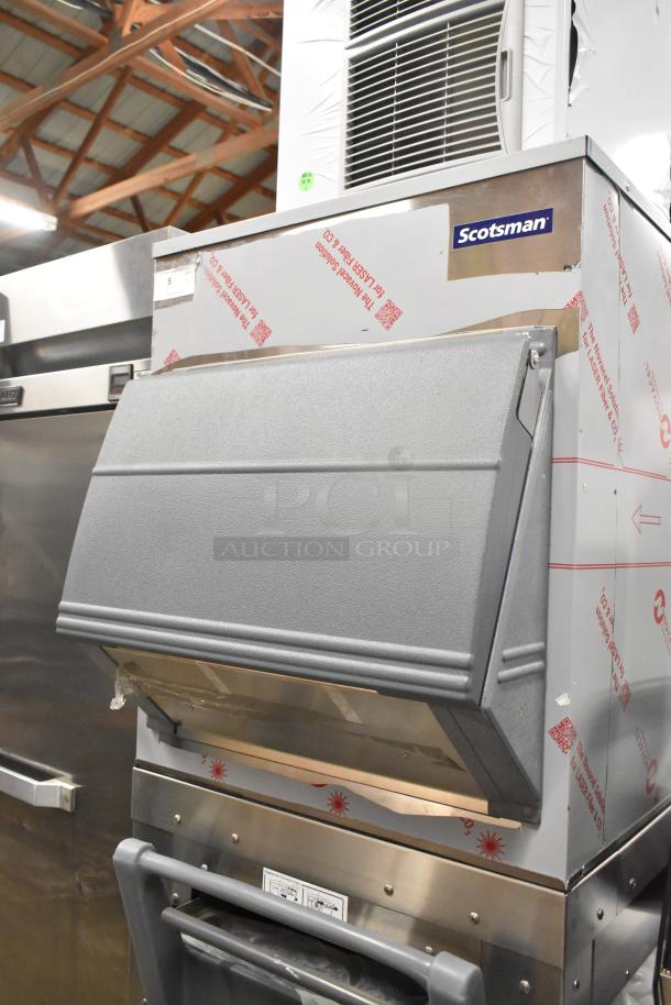 BRAND NEW Scotsman FS1222A-32B stainless steel ice head with bin on stand, featuring gray poly ice cart. 208/230V, 1 phase.