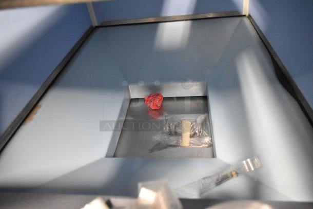 Stainless steel interior of Scotsman FS1222A-32B ice machine, showing minor scratches and tools inside. Brand new condition.