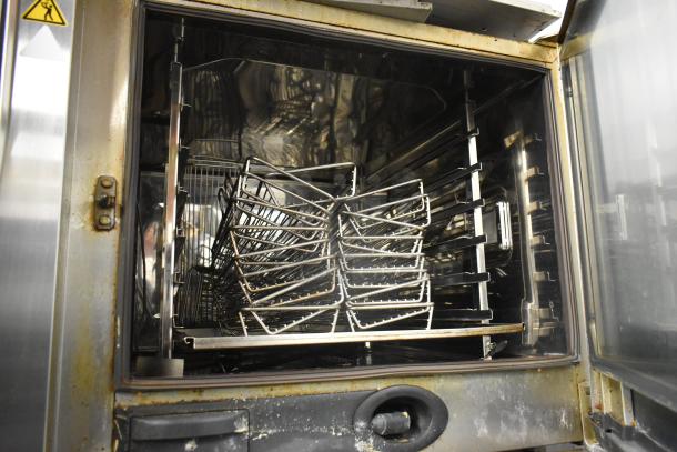Stainless steel commercial Rational SCCWE62/SCCWE102 convection ovens, interior view with racks, 480 volts, 3 phase.