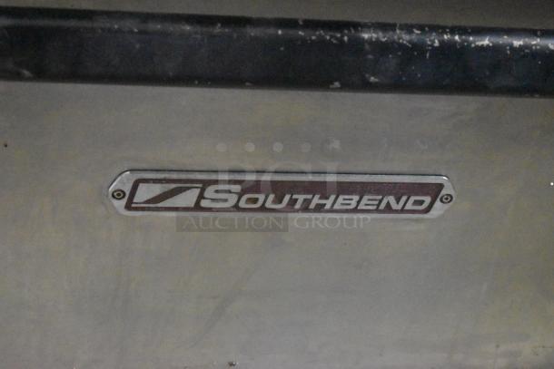 Southbend stainless steel commercial 10-burner gas range with two convection ovens, missing one spider grate.