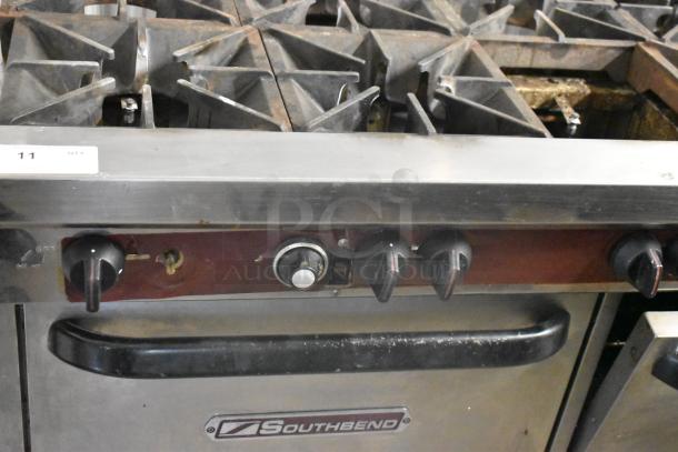Southbend stainless steel 10-burner gas range with 2 convection ovens, backsplash, and overshelf. Missing 1 spider grate.