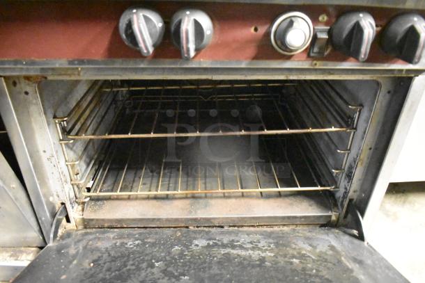 Southbend stainless steel commercial gas 10-burner range with 2 convection ovens, missing 1 spider grate. Features backsplash and overshelf. Used condition.