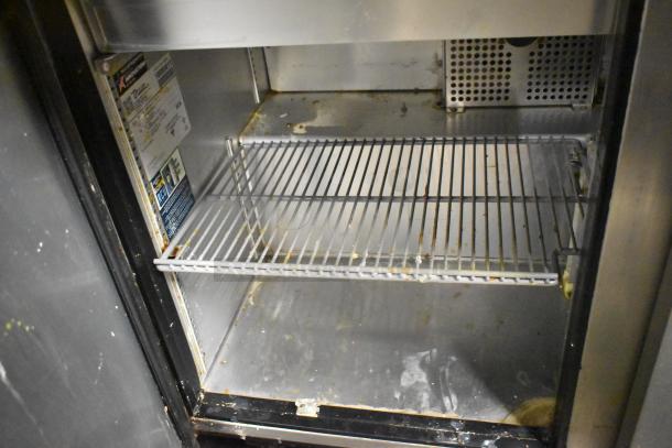 2021 True TSSU-72-30MB-ST-HC stainless steel commercial prep table, interior view showing shelves and visible wear.