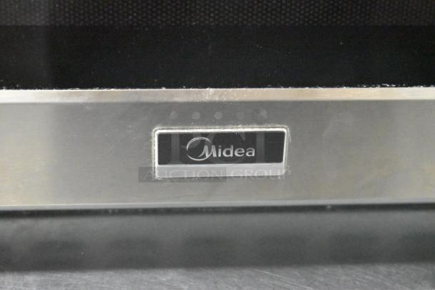 Stainless steel Midea 1034N1A commercial countertop microwave with logo. In original box, 120 Volts, 1 Phase.