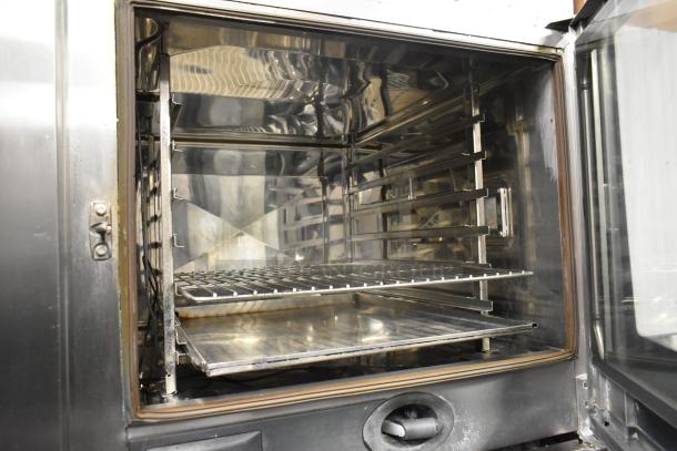Rational SCCWE62/SCCWE102 stainless steel convection oven interior, showing racks and clean condition. Electric, 480V, 3-phase.