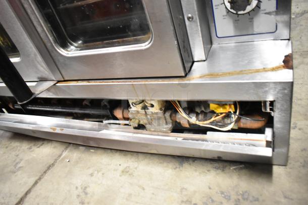 Garland SunFire stainless steel convection oven, natural gas, view-through doors, metal racks, thermostatic controls, metal legs. Visible wear.