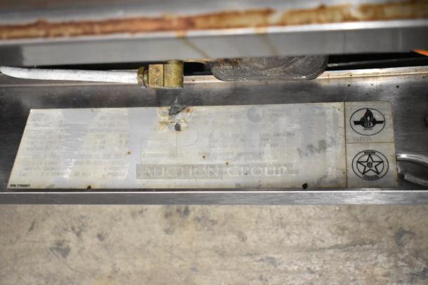 Garland SunFire stainless steel natural gas convection oven with view-through doors, metal racks, thermostatic controls. Certification labels visible.