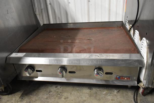 Ikon Stainless Steel Gas Flat Top Griddle, commercial countertop model, three control knobs, used condition, visible wear.