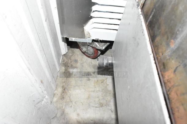 Ikon stainless steel commercial gas griddle, visible wheel, metal construction, signs of wear, counter model.