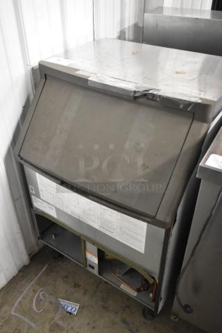 Manitowoc QF0406A stainless steel ice machine, commercial, self-contained, 115V, 1 Phase, visible exterior wear.