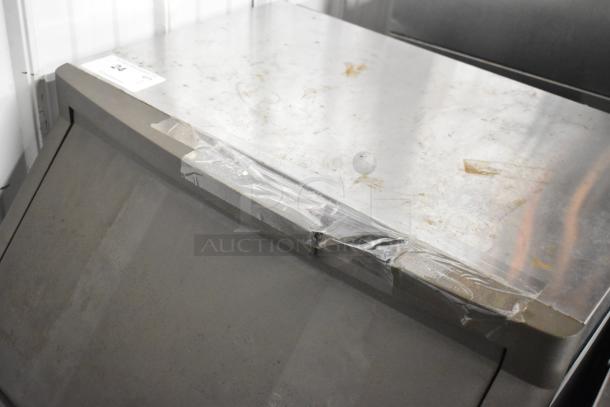 Manitowoc QF0406A stainless steel ice machine, 115 volts, 1 phase, commercial use, surface wear visible.