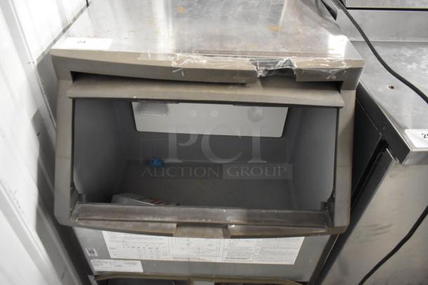 Manitowoc QF0406A stainless steel commercial ice machine, self-contained, 115 volts, visible wear, open door view.