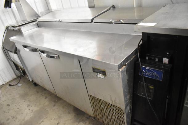 2019 True TPP-67 stainless steel commercial pizza prep table with two doors, commercial casters, and 115V power.