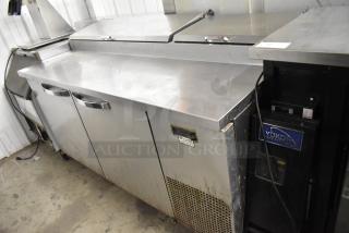 2019 True TPP-67 stainless steel commercial pizza prep table with two doors, commercial casters, and 115V power.