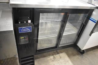 Yukon YBB49-2G-24SD commercial 2-door back bar cooler, glass doors, metal exterior, 115V, used. Yukon logo visible.