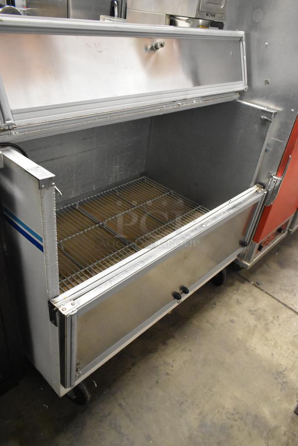 Beverage Air SMF49 commercial milk cooler with stainless steel body, open lid, adjustable wire racks, on commercial casters. 115V, 1 phase.