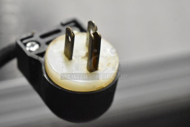 Beverage Air SMF49 stainless steel commercial milk cooler plug, 115 volts, 1 phase. Close-up of power plug.